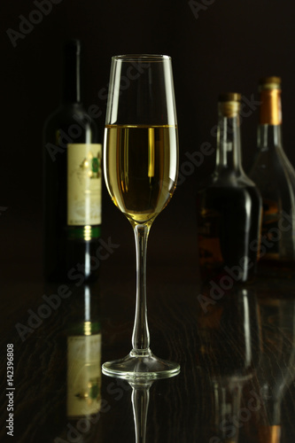 Wine glass and Bottle on a black mirror background
