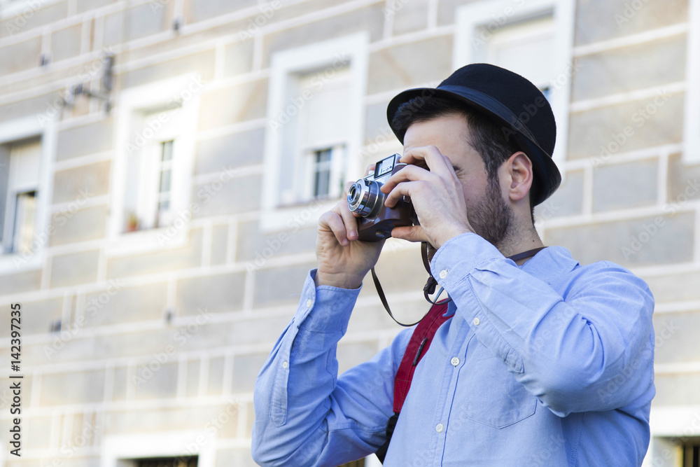 young traveller with the camera making tourism in the city young traveller with the camera making tourism in the city