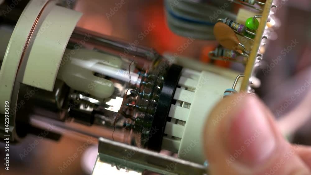 The master inserts the connector into the electronic gun of the old TV The master inserts the connector into the electronic gun of the old TV