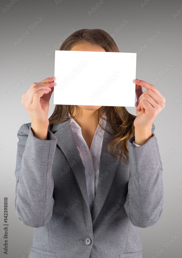 Business woman with blank card over face against grey background Business woman with blank card over face against grey background