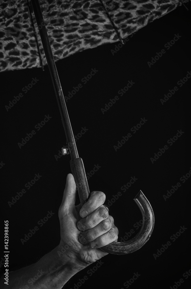 A man's hand holds an umbrella. A man's hand holds an umbrella.