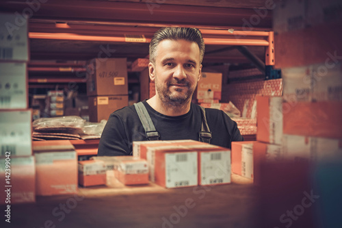 Storekeeper working in a warehouse photo