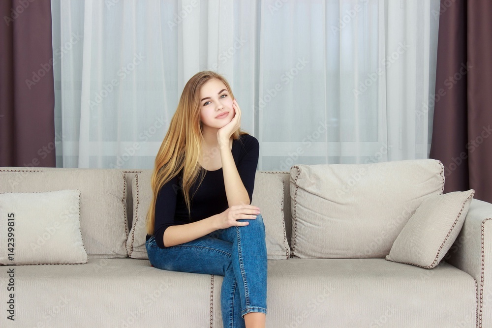 cute young girl relaxing on couch at home cute young girl relaxing on couch at home