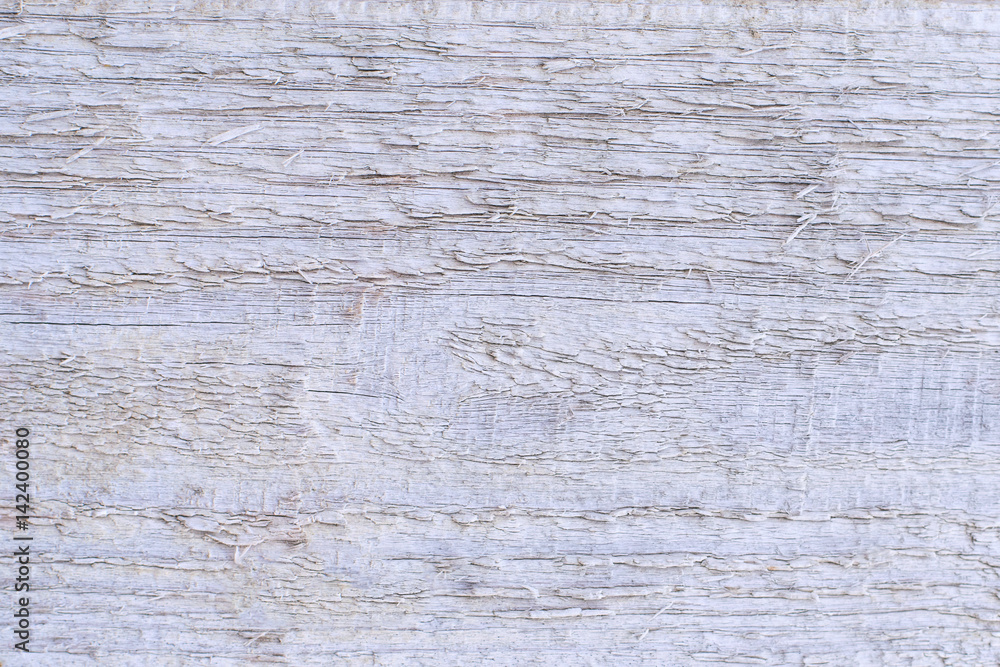 A wooden rough unplaned unpolished background with boards of white color old weathered. A wooden rough unplaned unpolished background with boards of white color old weathered.