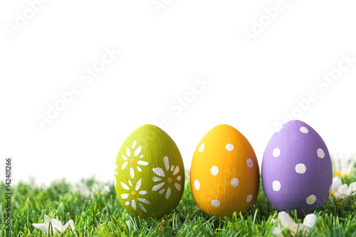 Row of Easter eggs on grass