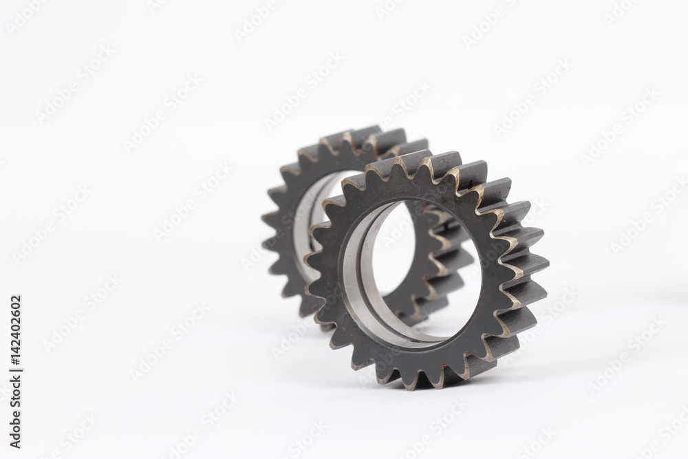 Small group of gears with their teeth engaged on a white background. Small group of gears with their teeth engaged on a white background.