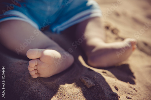 Toddler's feet. Baby's feet on the beach