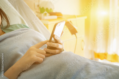 Medical healthy care patient Relaxing With Tablet pc  using iPads contact with doctors medical services emergency call.woman sending a text message in hospital  typing in information on mobile phone..