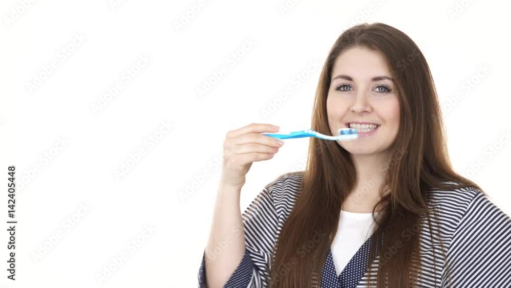 Woman holding brush for teeth cleaning. Happy positive smiling girl with toothbrush pointing on mouth. Oral daily hygiene. Studio shot isolated on white background 4K ProRes HQ codec Woman holding brush for teeth cleaning. Happy positive smiling girl with toothbrush pointing on mouth. Oral daily hygiene. Studio shot isolated on white background 4K ProRes HQ codec