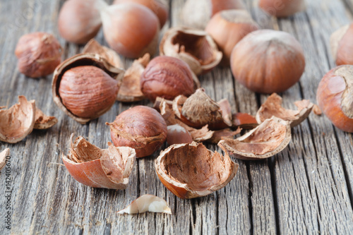 Hazelnut heap on wooden table, selective focus