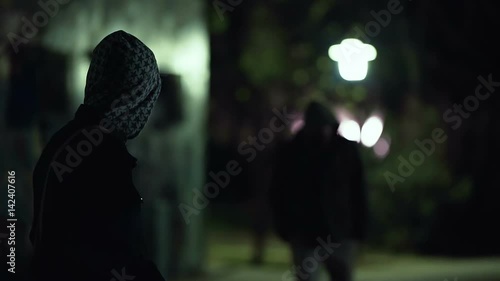 Two hooded men doing transaction at night,suspicious activity