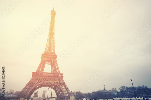 The Eiffel tower is one of the most recognizable landmarks in the world under sun light selective focus vintage color