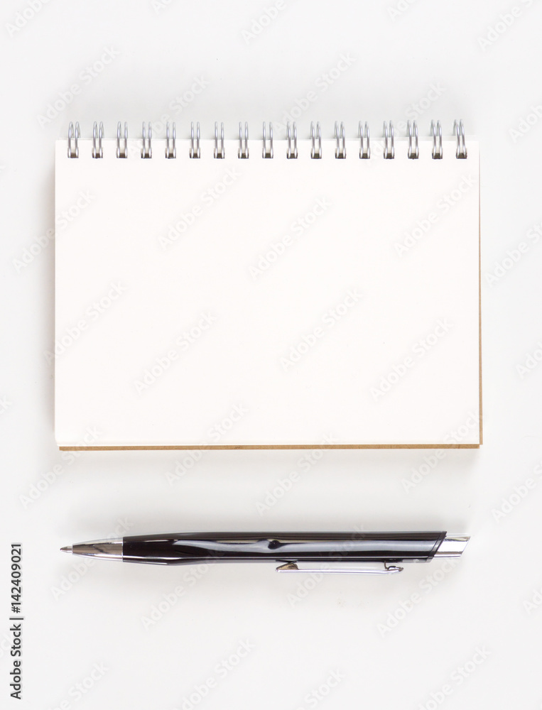 Top view of an opened notebook on a wooden desk,pen book with blank pages on wood table-can be used for montage or display your products Top view of an opened notebook on a wooden desk,pen book with blank pages on wood table-can be used for montage or display your products