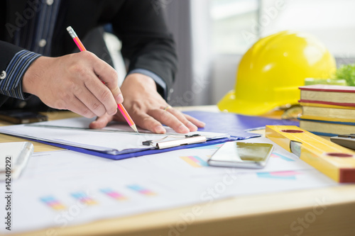 architect drawing on architectural Projecting with pencil on the urban drawings. home planning,Architectural construction plans, pencil and ruler on the desk,selective focus,vintage color