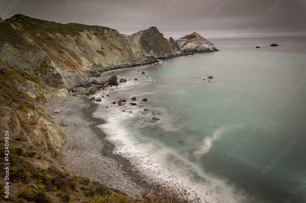 Rocky beach and cliffs close to Pacific Coast Highway at Willow Creek point, California, USA