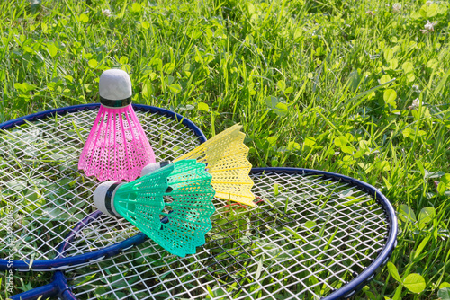 Badminton rackets and shuttlecocks on grass