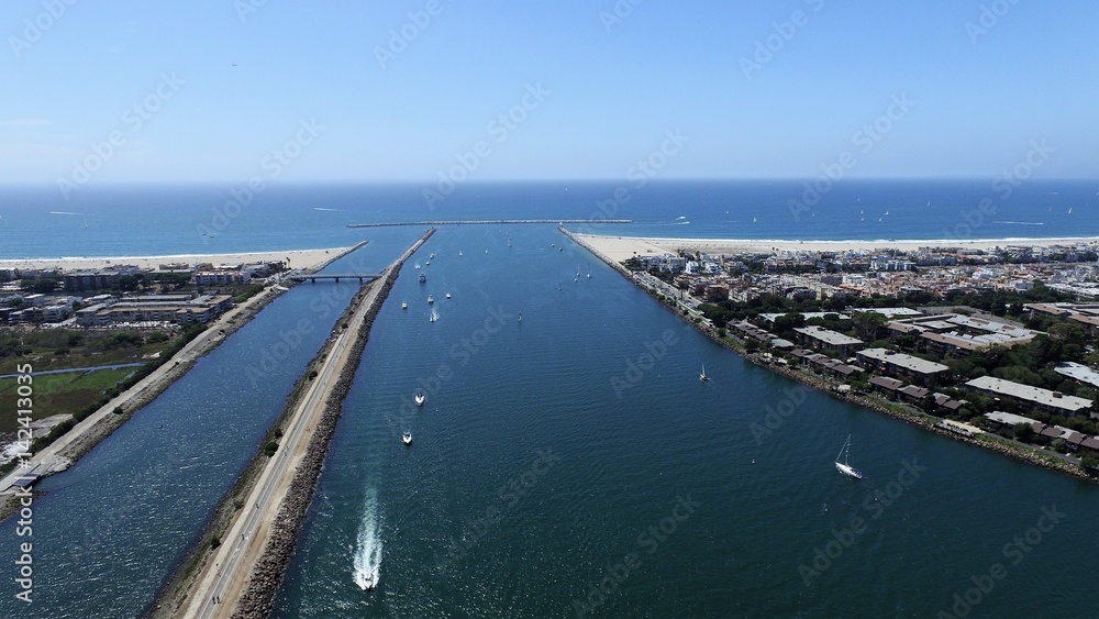 Panoramic fly over Long Beach marina and harbor with speed boats, yachts and sky jets