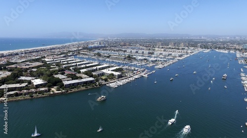 Panoramic fly over Long Beach marina and harbor with speed boats, yachts and sky jets
