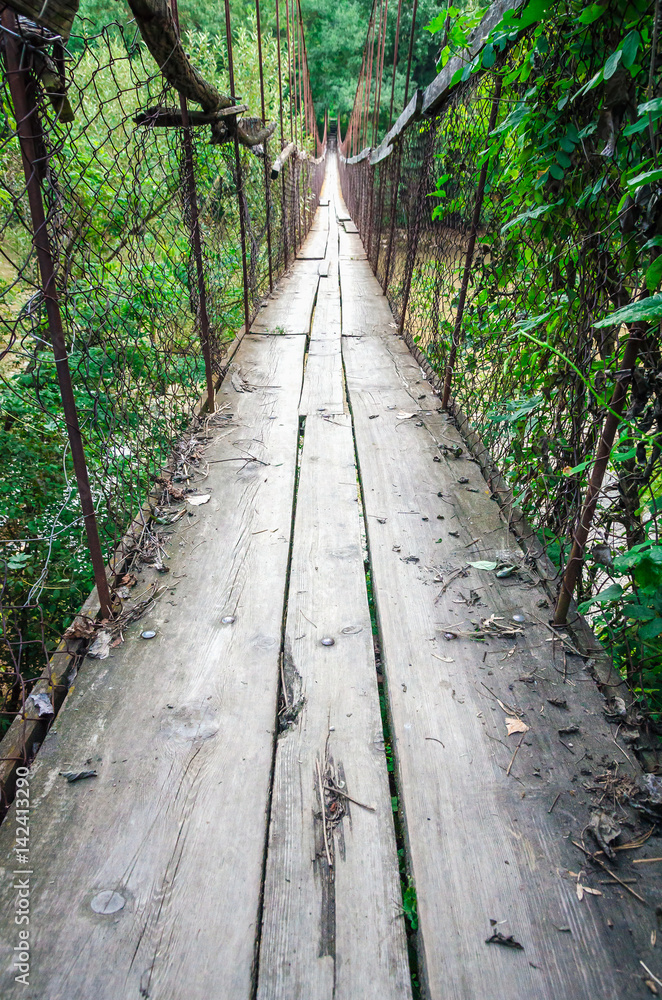 Obraz premium OId ruined rust cable bridge with