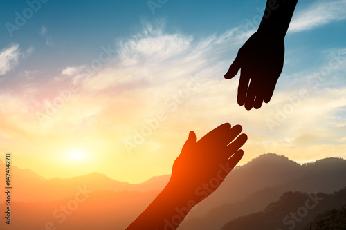 helping hand with the sky sunset background photo