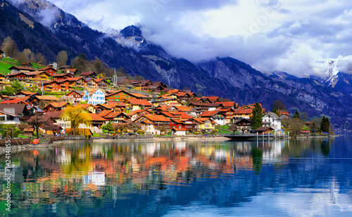 Old town and Alps mountains reflecting in lake, Switzerland photo