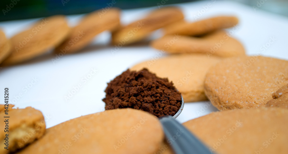 Heart shape made of gingerbread and teaspoon with black coffee Heart shape made of gingerbread and teaspoon with black coffee