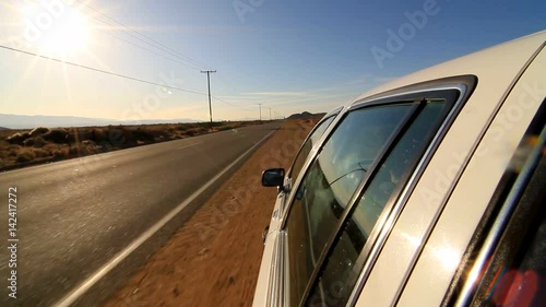 Car driving on deserted road. Car parking on the side of the road.