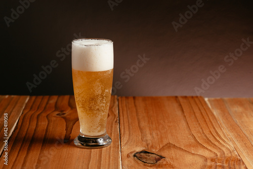 Glass of beer on wood table