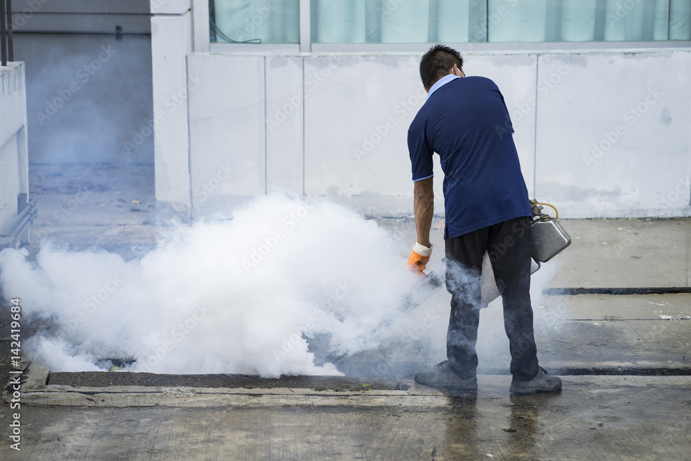 The man fogging to eliminate mosquito The man fogging to eliminate mosquito
