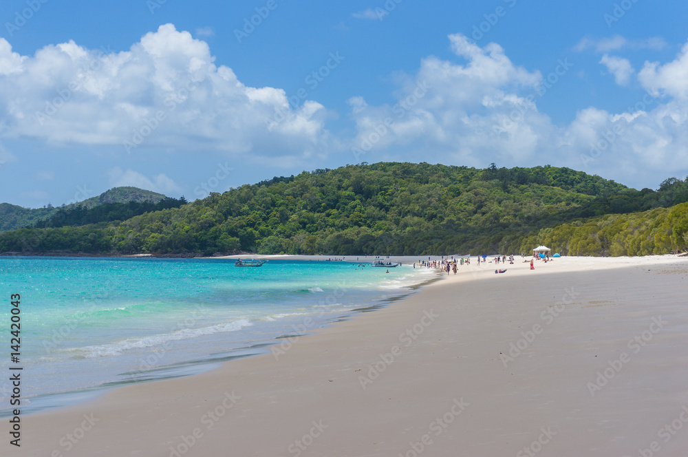 Tropical island beach with people in the distance. Summer background
