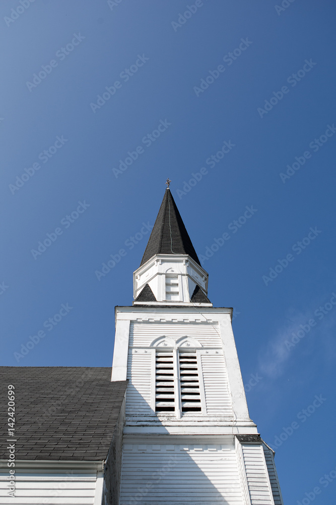 Church steeple against a brilliant blue summer sky