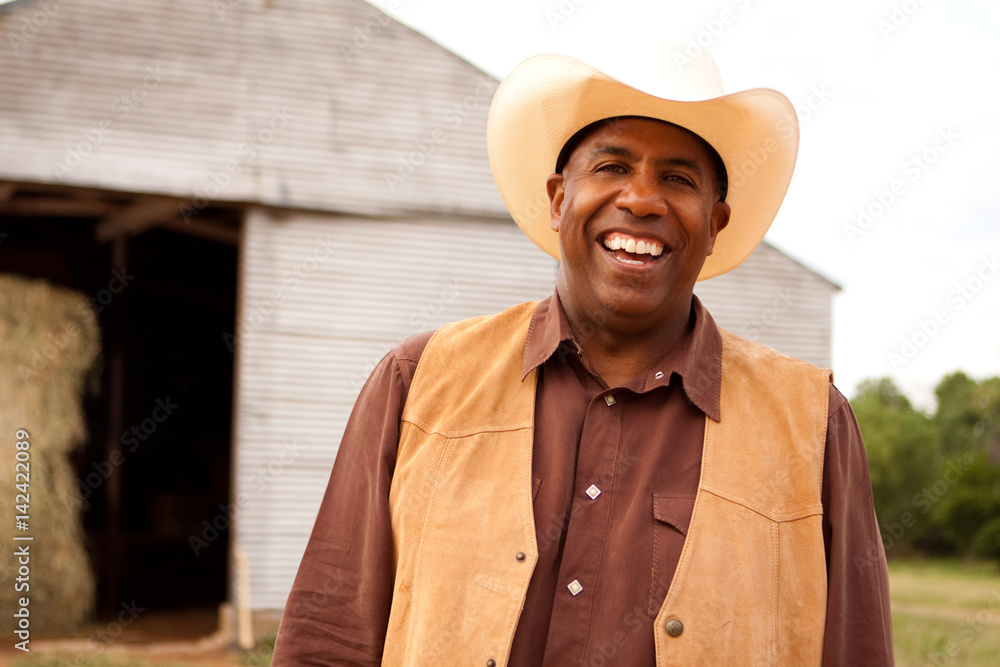 African American cowboy smiling and laughing. African American cowboy smiling and laughing.