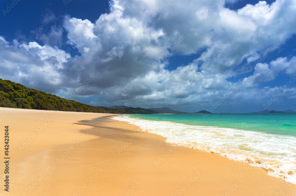 Beautiful tropical beach with piqturesque cloudscape