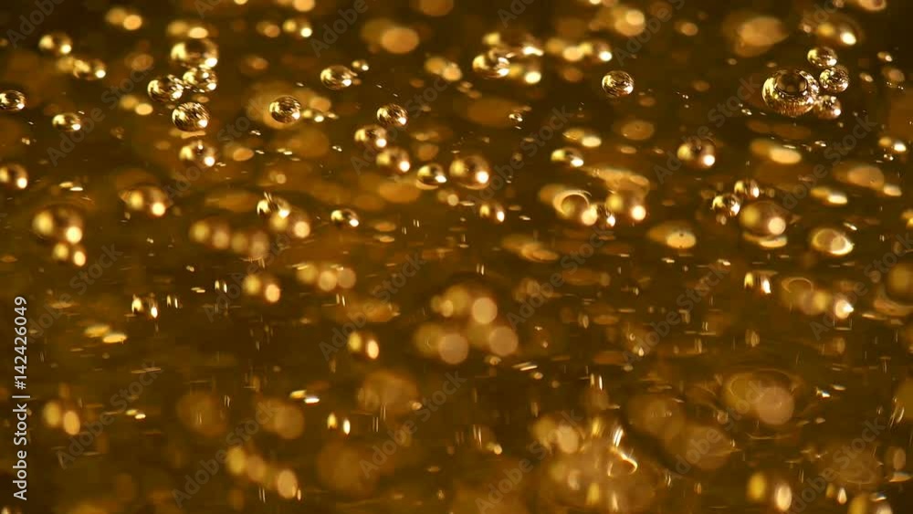 The oil bubbles slowly rise upwards The oil bubbles slowly rise upwards