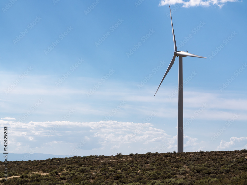 Sustainable Energy Background with Single Windmill Wind Turbine and Blue Sky