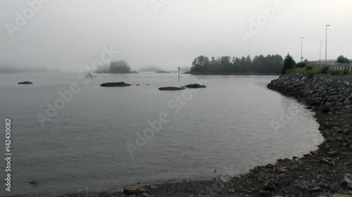 Wallpaper Mural Yacht sails on calm water of Pacific Ocean on background coast road in Alaska. Amazing landscapes in the fog. Beautiful rest and tourism in a cool climate. Unique picture of nature in America. Torontodigital.ca