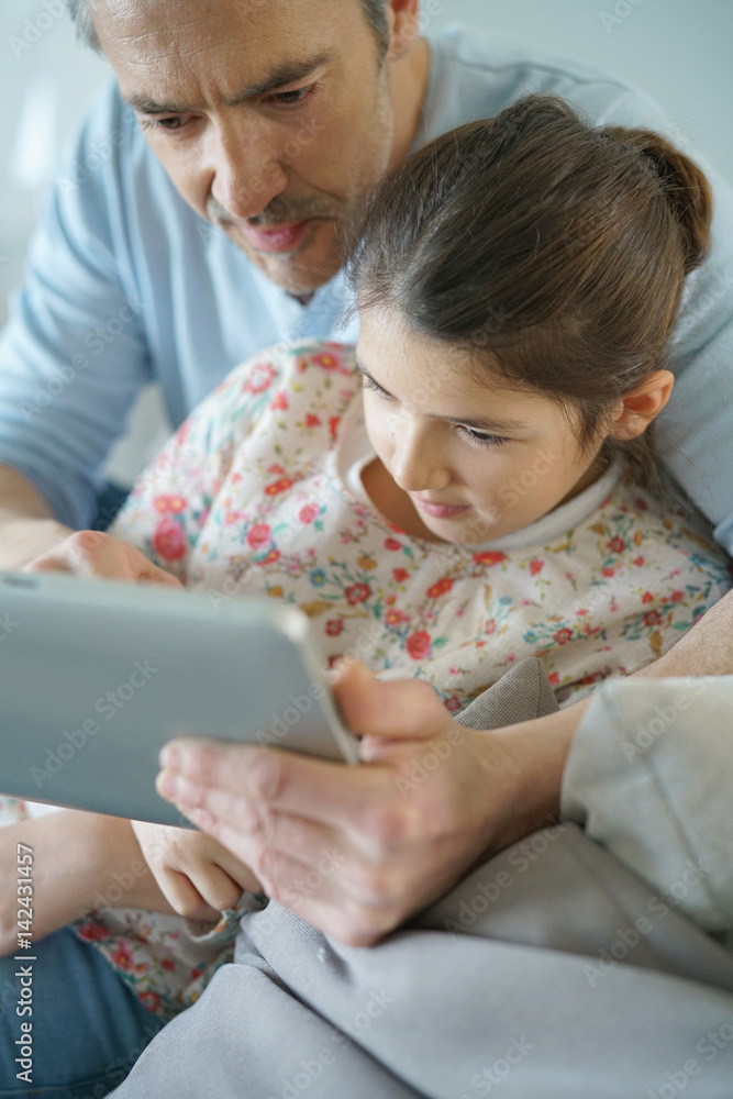 Dad with daughter websurfing on digital tablet Dad with daughter websurfing on digital tablet