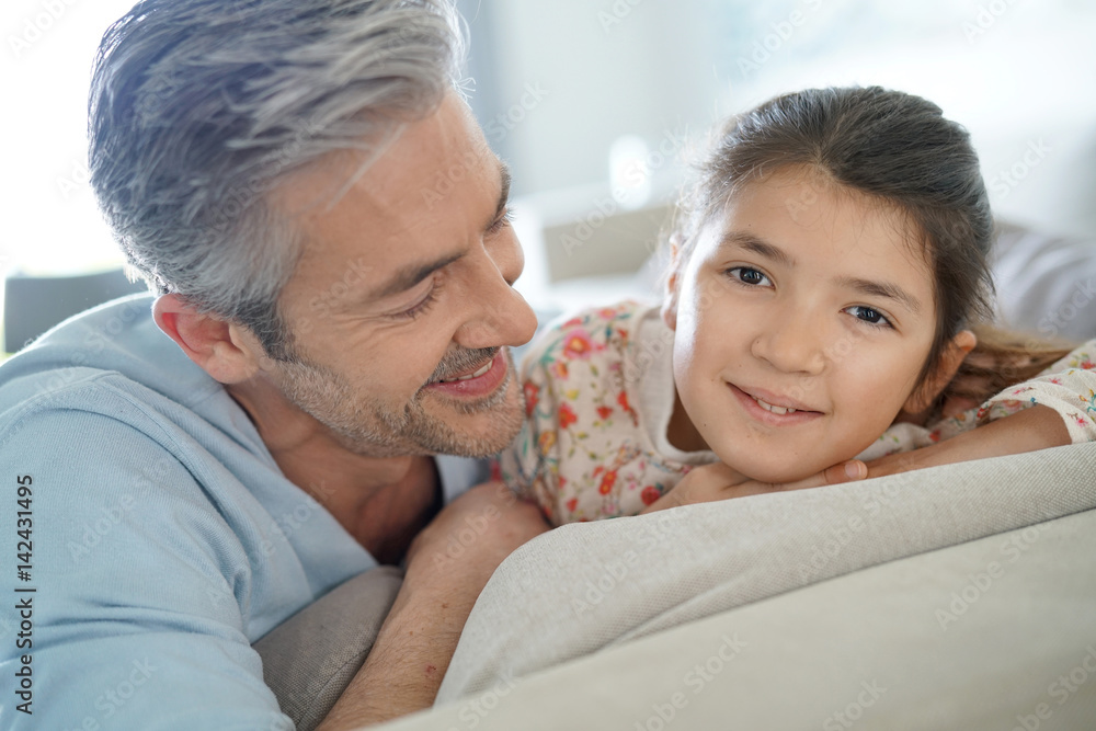 Portrait of father and daughter in sofa Portrait of father and daughter in sofa