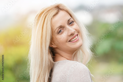 Portrait of attractive blond woman standing outside