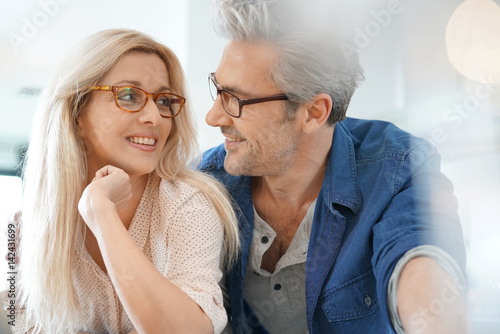 Portrait of happy middle-aged couple with eyeglasses