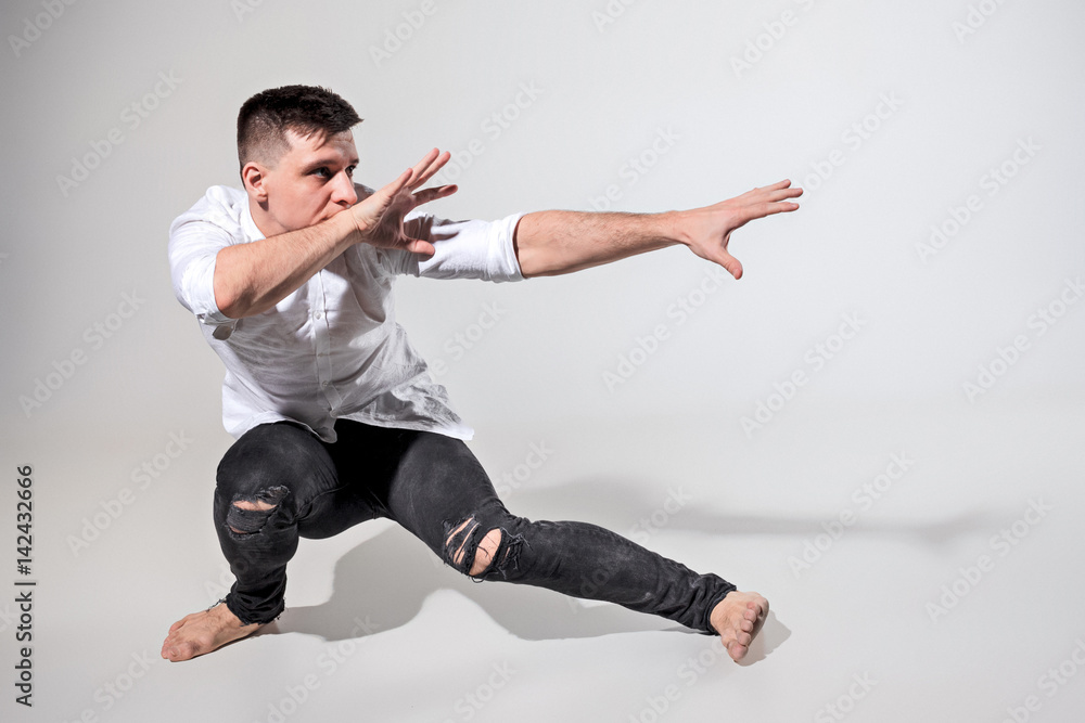 The young man dancing on gray