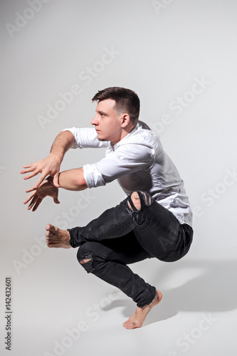 The young man dancing on gray