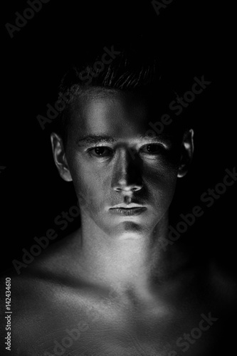 A handsome man of athletic build, completely covered in gold paint.Studio photos, With Hard lite, Black and white © gal2007
