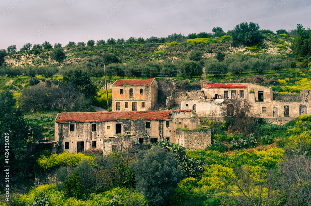 what is left from deserted houses in an abandoned village in Crete.
