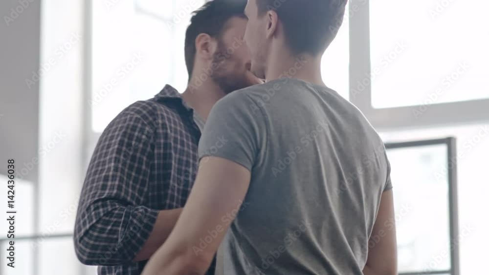 Medium shot of happy male friends meeting and pound hugging each other, then chatting about life Medium shot of happy male friends meeting and pound hugging each other, then chatting about life