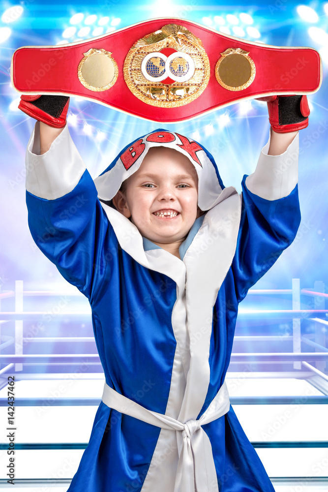 Little boy boxer holding Boxing championship belt.The athlete in