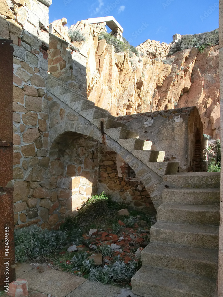 Arched stairs in old stone fortification, Caprera Island, Sardinia, Italy