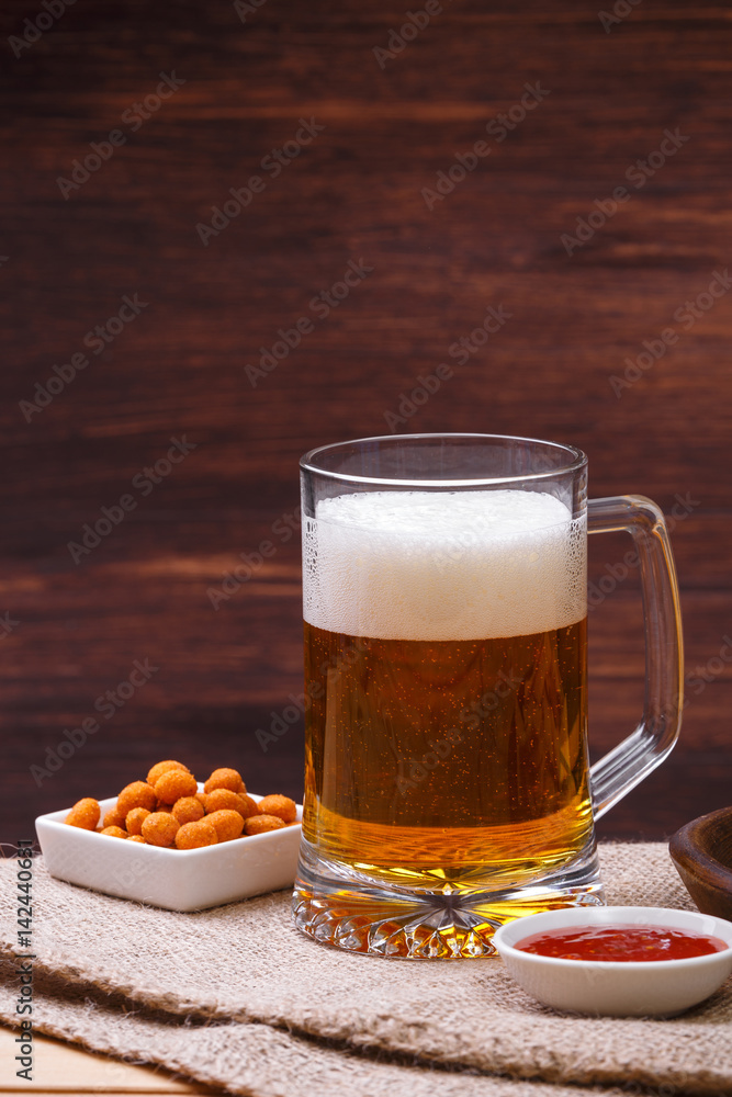 Glass of beer. Mexican salsa nuts. Appetizer with sweet salsa or chilli sauce. Mug or pint of ale. On rustic wooden background. Glass of beer. Mexican salsa nuts. Appetizer with sweet salsa or chilli sauce. Mug or pint of ale. On rustic wooden background.
