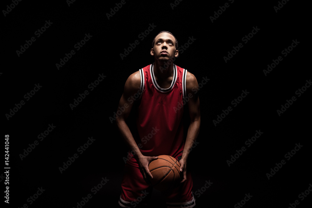 african sporty man in sports uniform playing basketball on black african sporty man in sports uniform playing basketball on black