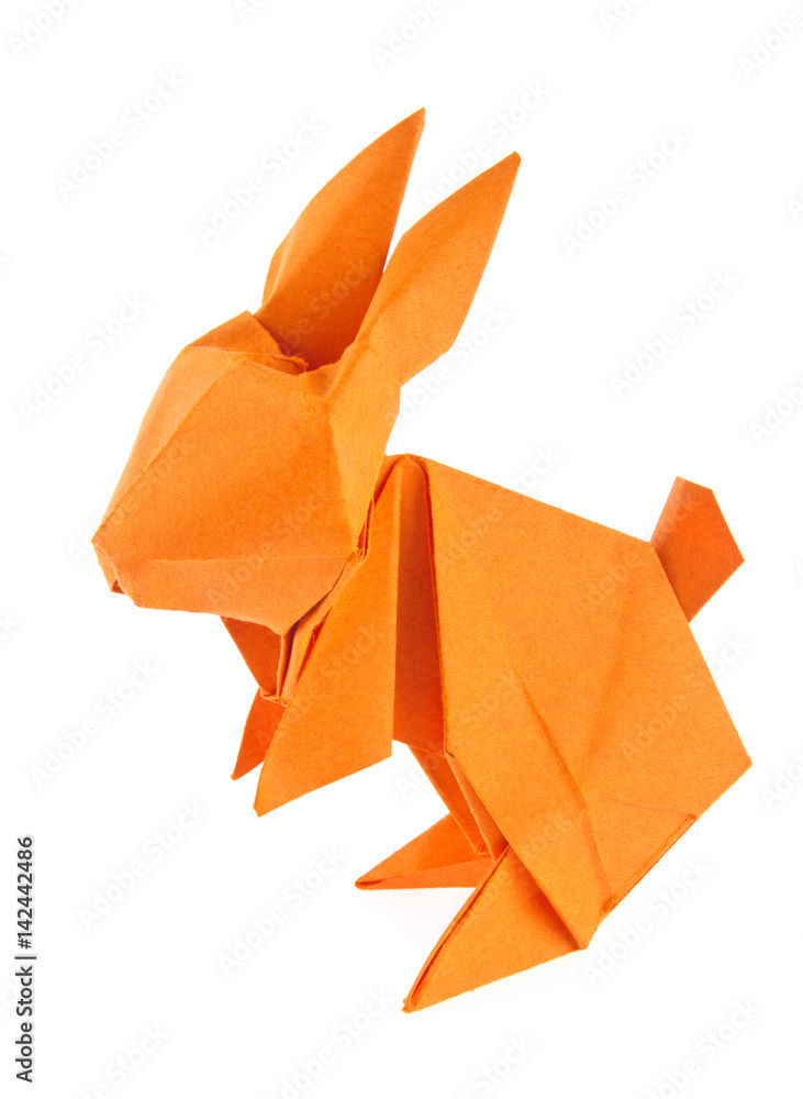 Fototapeta premium Orange easter bunny of origami, isolated on white background.